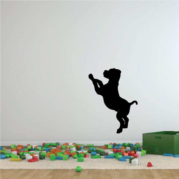 Black puppy silhouette wall decal with raised paw and tail