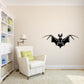Black bat wall decal with wings spread and small crest detail.