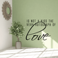 Wall decal with quote text and cursive 'Love' lettering, black on light background