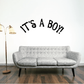 Black script wall decal reading “It’s A Boy!”