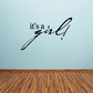 Baby shower wall decal reading "it's a girl!" in black script