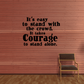 Black wall decal quote: It’s easy to stand with the crowd; it takes courage.
