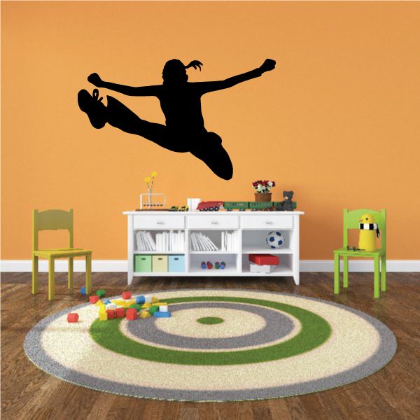 Jumping cheerleader wall decal in black silhouette with pom-poms