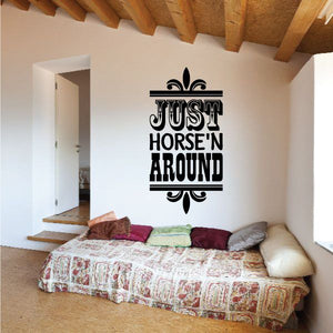 Black vinyl wall decal quote “JUST HORSE'N AROUND” with fleur-de-lis accents