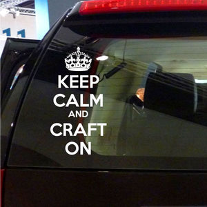 Vinyl decal with crown icon and text KEEP CALM AND CRAFT ON on car window