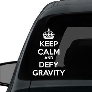 Car window decal with crown and text 'Keep Calm and Defy Gravity'