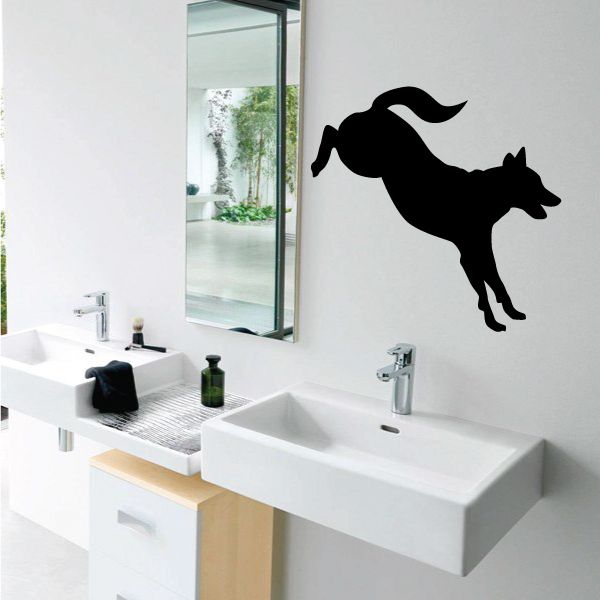 Kicking dog decal, black dog silhouette kicking on wall above sinks