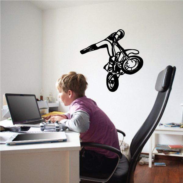 Motocross dirt-bike decal of rider performing kick-out stunt