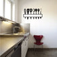 Kitchen utensils wall decal with black utensil silhouettes on a hanging rack