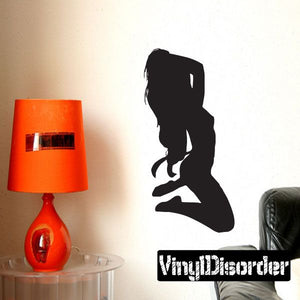 Kneeling stripper silhouette decal, black figure on wall with white logo text