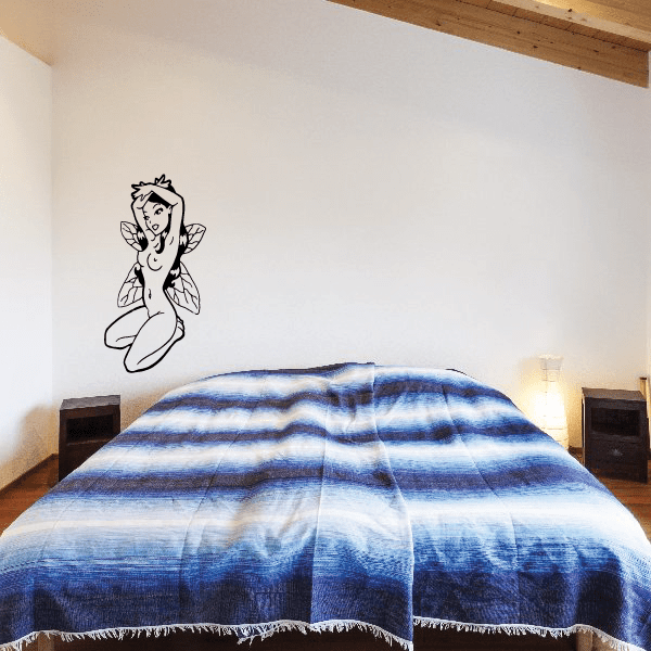 Fairy wall decal of a kneeling surprised fairy holding a small wand