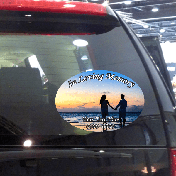 Round car window sticker with In Loving Memory over sunset couple silhouettes.