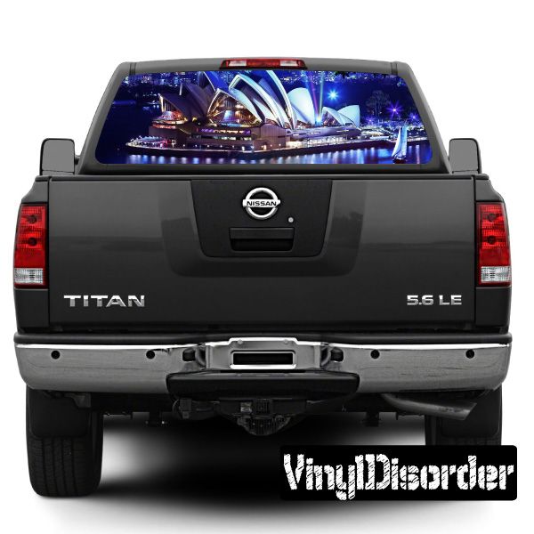 Pickup truck rear with dark tailgate and city landmark graphic in rear window
