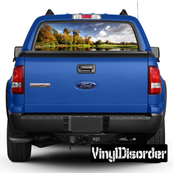 Pickup truck rear window landscape graphic wrap, blue vehicle body, tailgate view