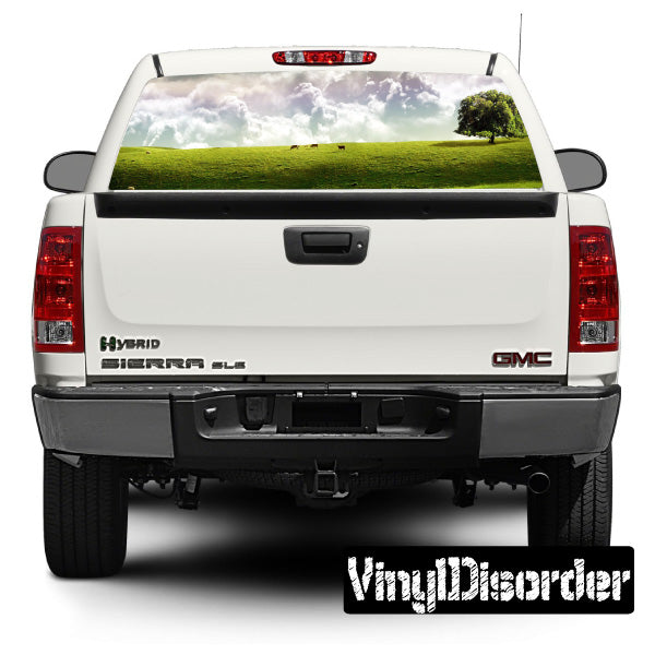 Car rear window landscape decal with green hills, clouds, and a tree on glass