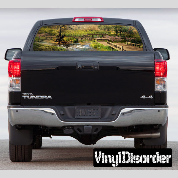 Pickup truck rear window with landscape graphic view, black trim and tail lights