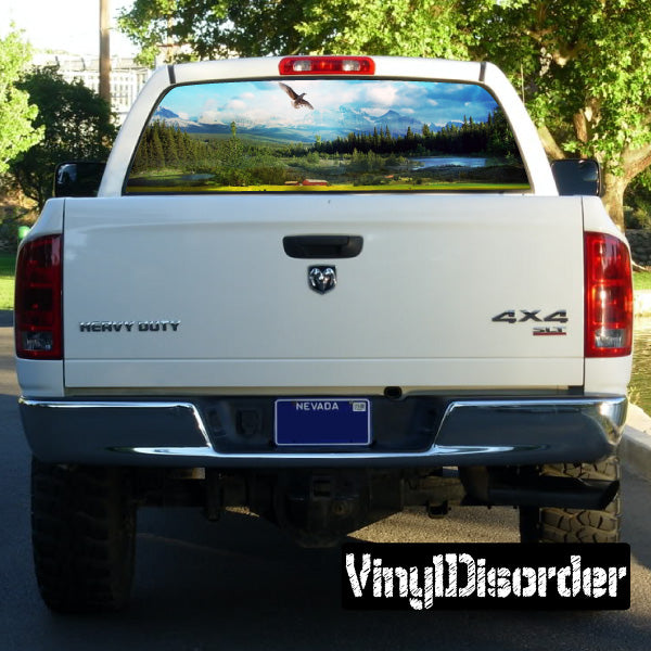Truck tailgate rear window graphic with scenic mountain landscape and bird