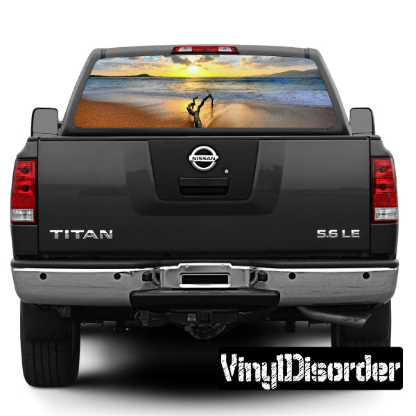 Rear window landscape view graphic for vehicle, depicting ocean and sunset scene