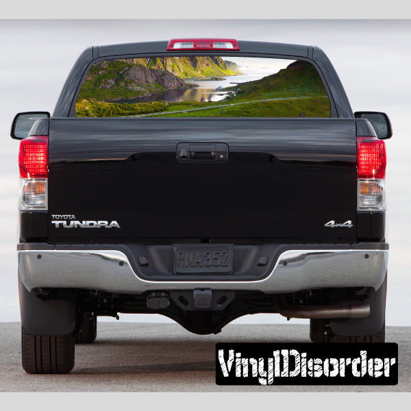 Pickup truck rear window with landscape graphic decal and tinted tailgate panel