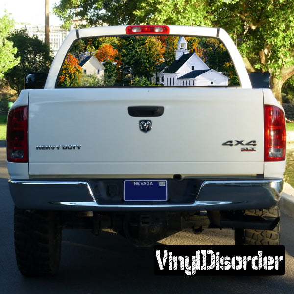 Truck rear window graphic with colorful house landscape on white pickup