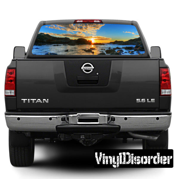 Rear window graphic decal with landscape sunset over ocean on dark car