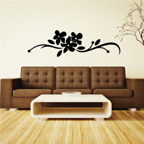 Black floral vine wall decal with three-petal flowers and swirls