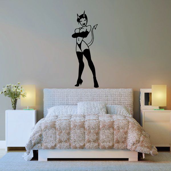 Black devil girl decal with horns and tall boots, smiling.