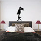 Leering parrot decal with black bird silhouette and big white eye on wall