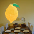 Polygon lemon wall sticker with green leaf, yellow geometric fruit shape