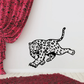 Leopard chasing decal with black outline and spotted body design