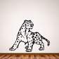 Leopard turning wall decal with black spots and curled tail on light background