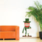 St. Patrick's Day leprechaun sticker, green outfit and hat, holding a sign
