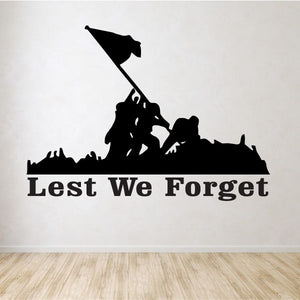 Wall decal featuring black soldier silhouette with flag and text Lest We Forget