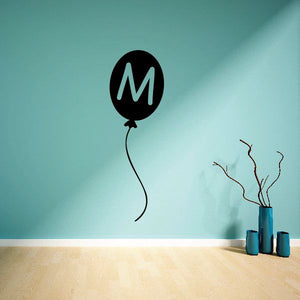 Letter M balloon wall decal with black balloon and green M, curly string