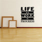 Wall quote decal reading 'Life is a Work in Progress' in black and white