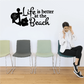 Beach wall decal with black cross, flowers, and 'Life is better at the Beach' lettering.