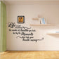 Inspirational vinyl wall decal with black cursive quote and decorative swirls