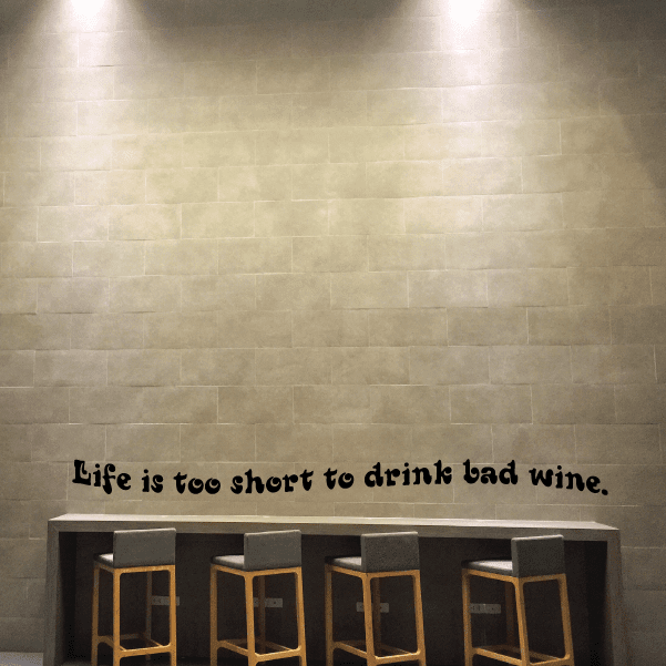 Black wall decal with text: "Life is too short to drink bad wine."