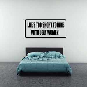 Rectangular wall decal with black border and bold text: “LIFE'S TOO SHORT TO RIDE”