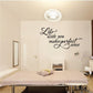 Wall decal reading “Life with you makes perfect sense” in cursive script with glasses
