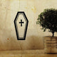 Light coffin decal with black outline and centered plus symbol