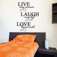 Inspirational wall decal with stacked text: LIVE, LAUGH, LOVE in black script and swirls