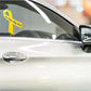 Yellow awareness ribbon vinyl sticker with small black text