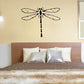 Dragonfly wall decal with long segmented body and spread wings, black outline.
