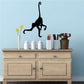 Long-tailed monkey wall decal in black, silhouette with raised arms and long upward tail