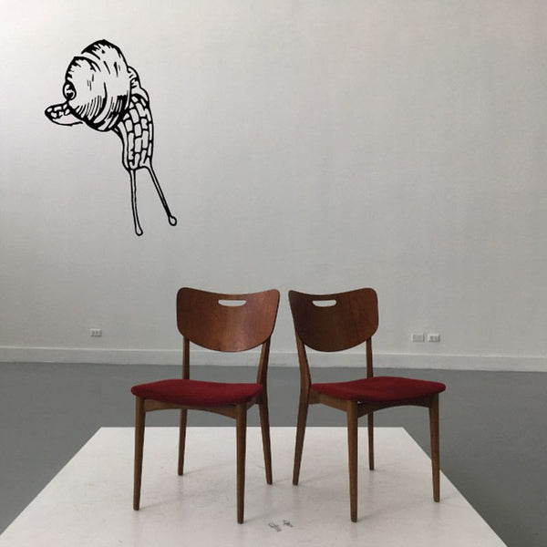 Snail decal with eyes and antenna, looking upward on a wall