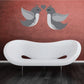 Love birds and heart sticker: two gray birds face a dark heart above a white oval