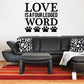 Wall decal with text 'LOVE IS A FOUR LEGGED WORD' and four paw prints