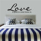 Wall decal reading "Love is good to come home to." in cursive script