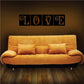Love wall decal in tiled frame, four black squares spelling LOVE with swirls